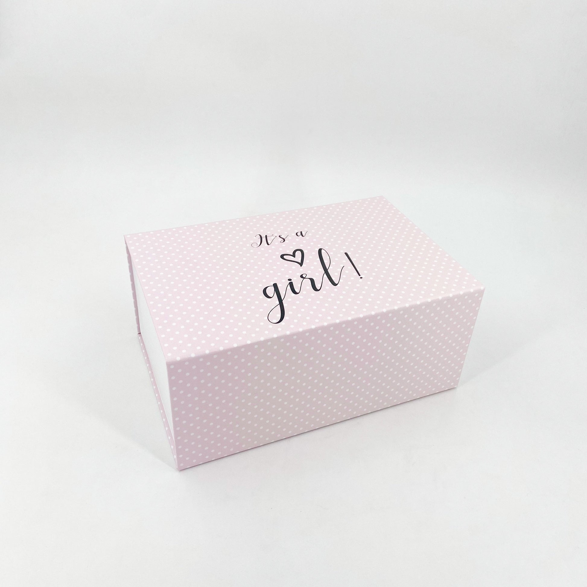 Rosa Magnetschachteln mit weißen Punkten mit der Aufschrift "Its a girl"