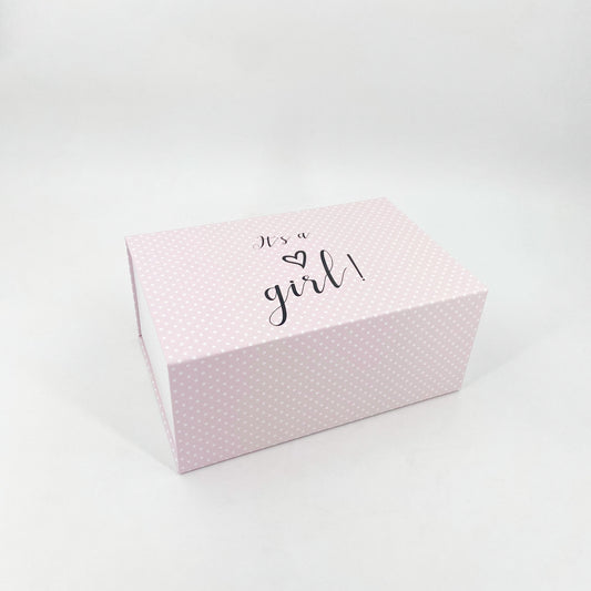 Rosa Magnetschachteln mit weißen Punkten mit der Aufschrift "Its a girl"